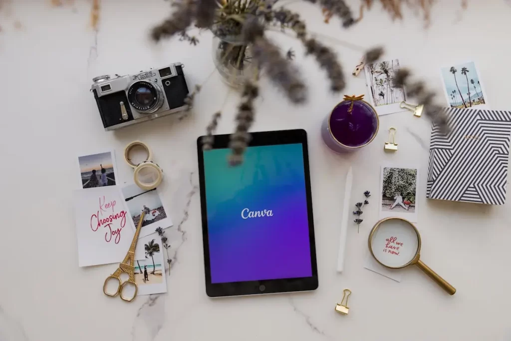 Canva Logo on tablet and other objects on a table -
